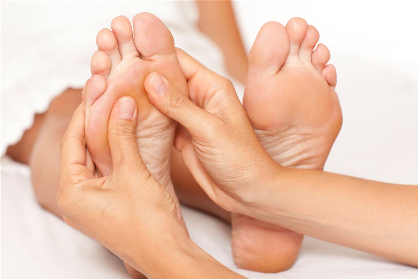 Close-up of a reflexology treatment, working both feet